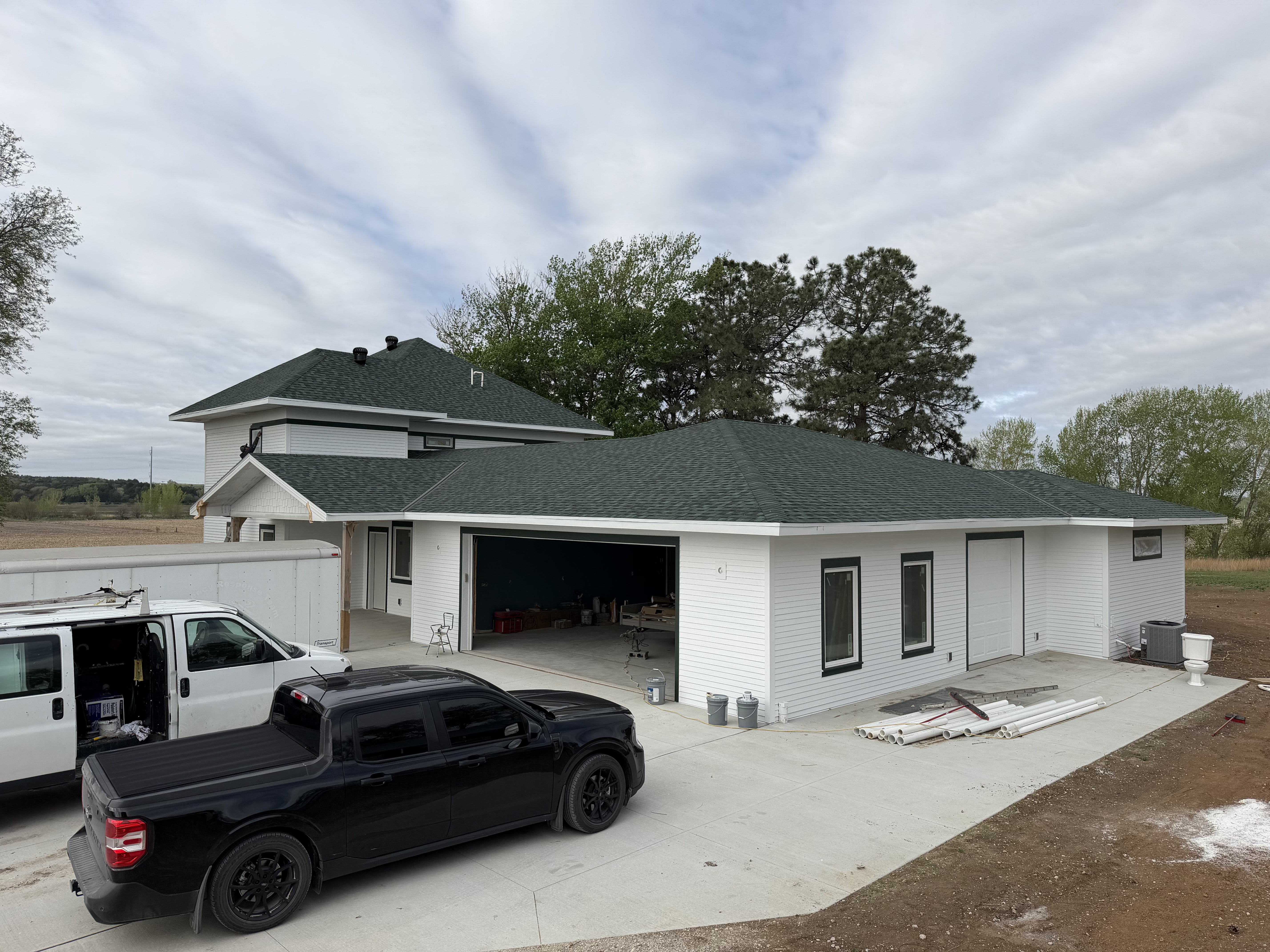 New-build home with a fresh green roof and crisp white exterior