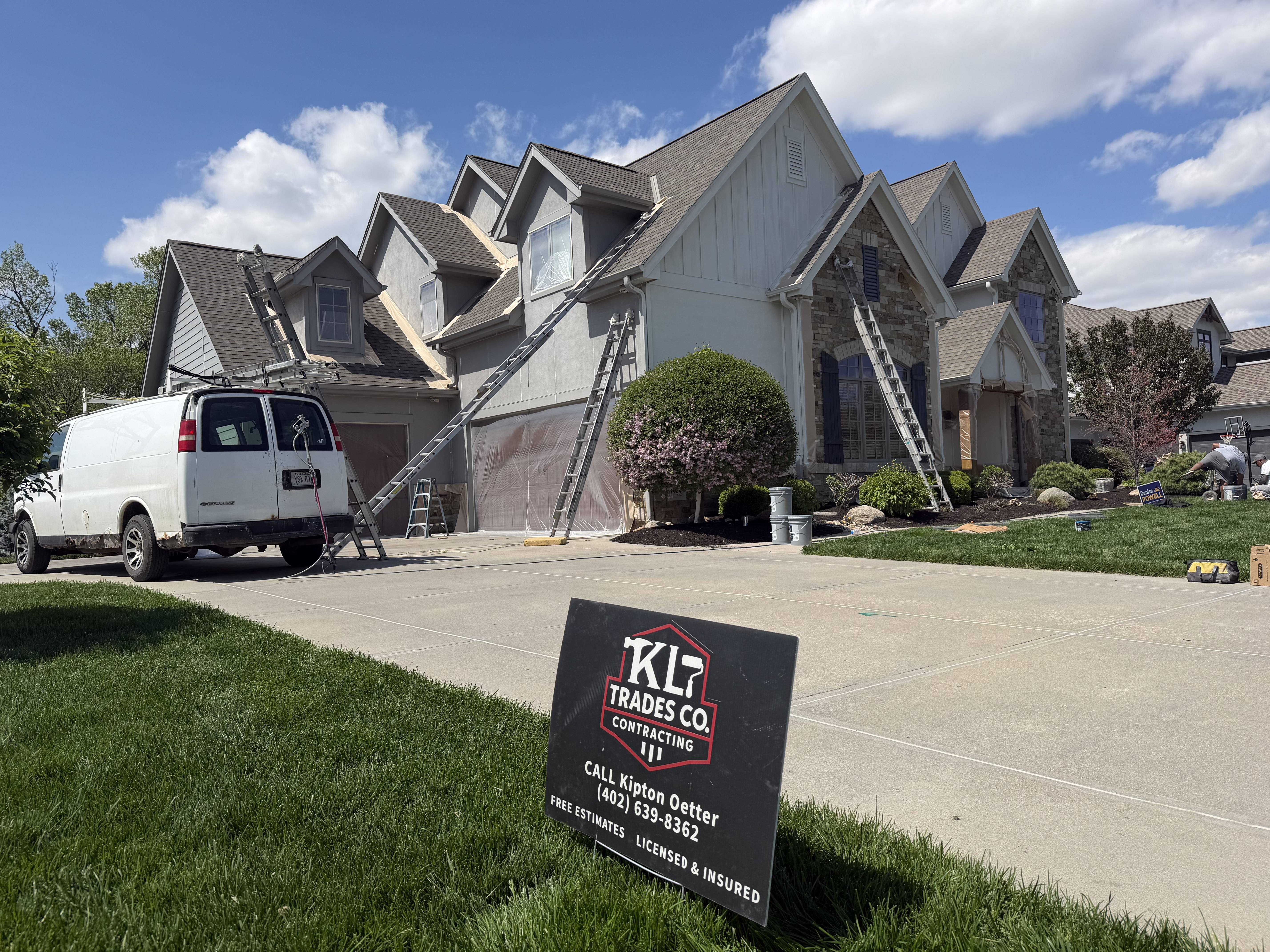 The KL Trades Co. crew and company van on a residential job site