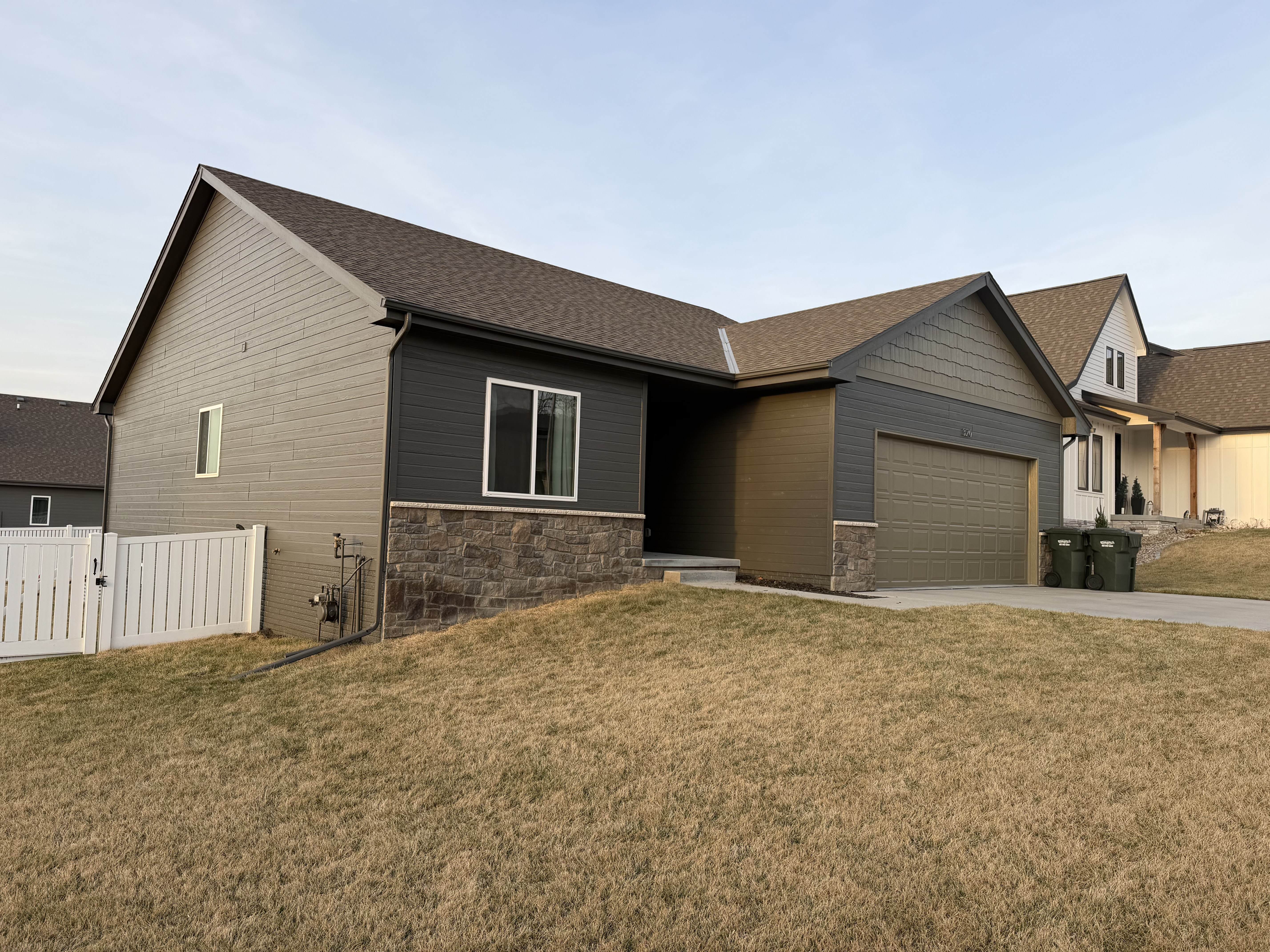 Charcoal and tan ranch exterior with stone accents